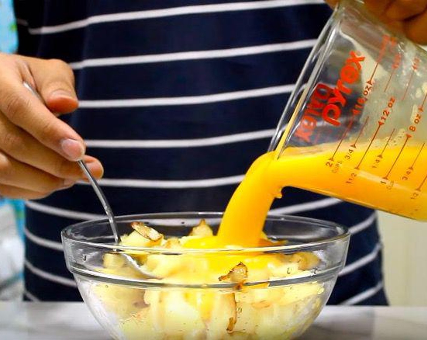 step 4 In the mixing bowl with the potato and onion, add the eggs. Mix together. Divide the mixture evenly between two containers.