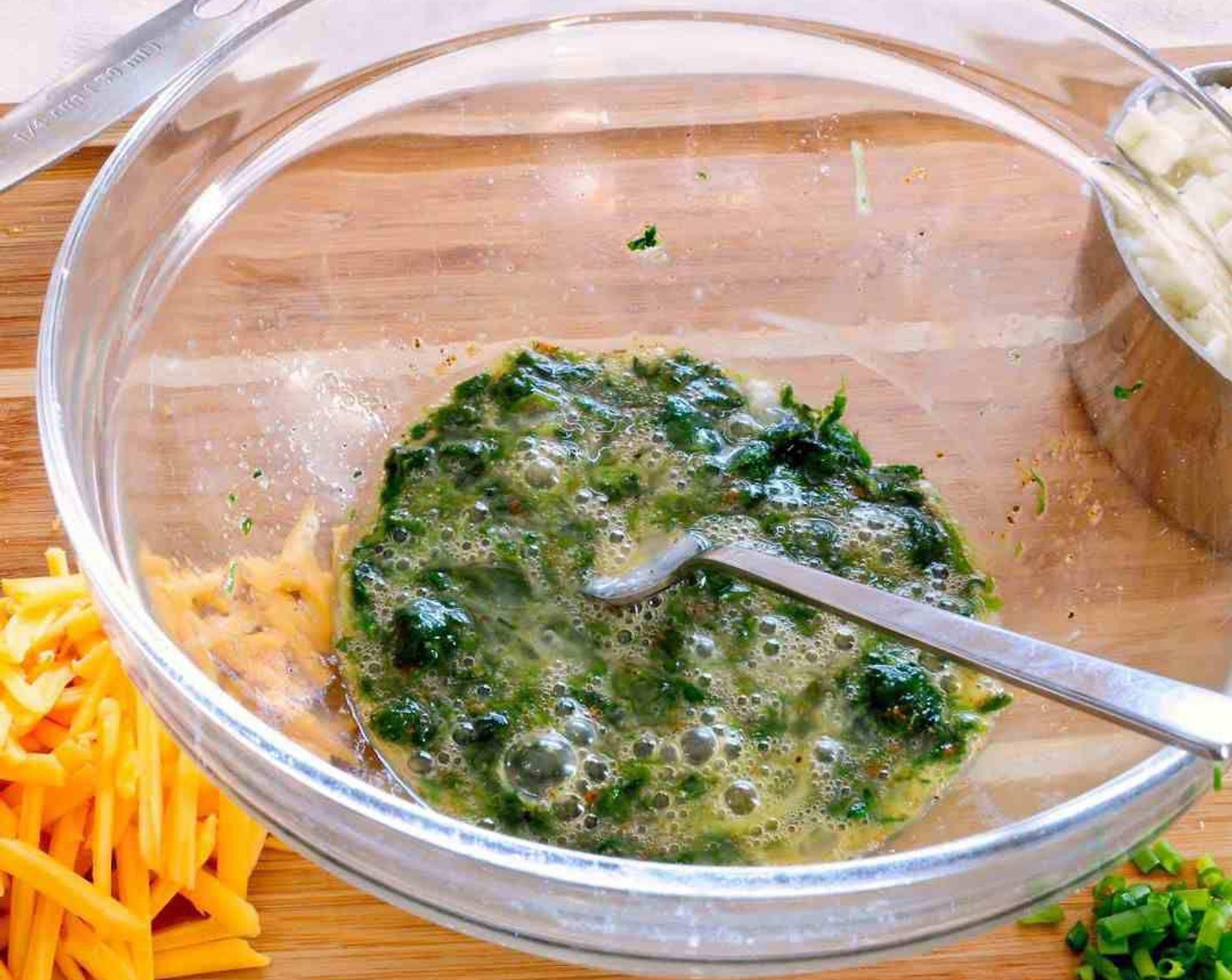 step 1 In a medium bowl, mix together Egg (1), Frozen Spinach (1/3 cup), Seasoned Salt (1/4 tsp), Onion Powder (1/8 tsp), and Ground Black Pepper (1/8 tsp).