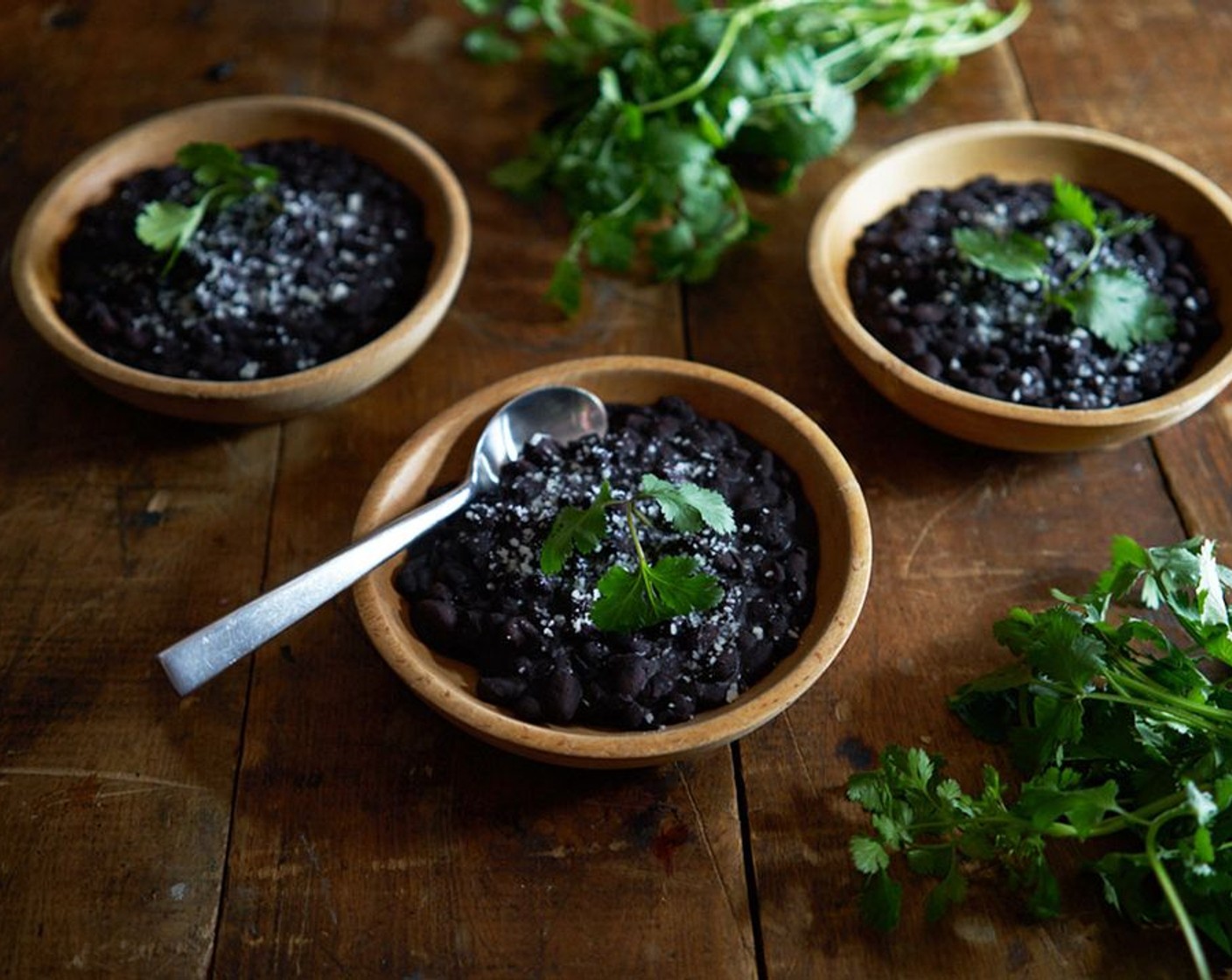 step 5 Once beans are cooked all the way through, add the Kosher Salt (1/2 Tbsp) and simmer for another 10-15 minutes. Serve topped with crumbled Cotija Cheese (to taste) on top, garnish with Fresh Cilantro (to taste).