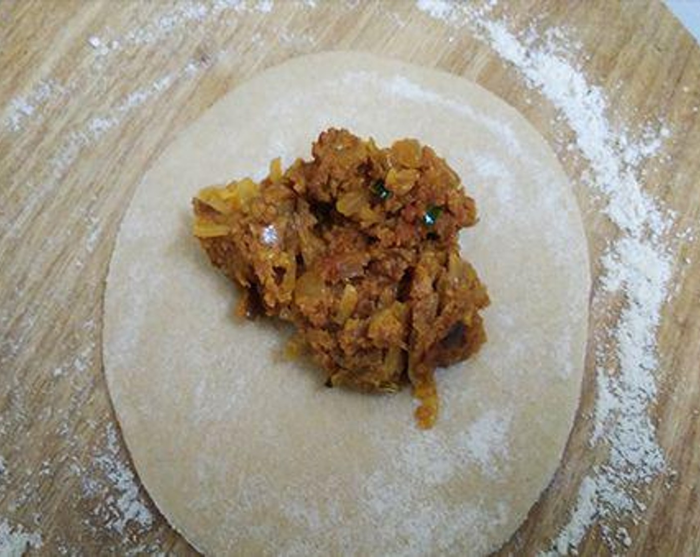 step 6 Take small portions of dough, dust some flour on your rolling board and make small rotis. Keep little keema mixture in the roti.