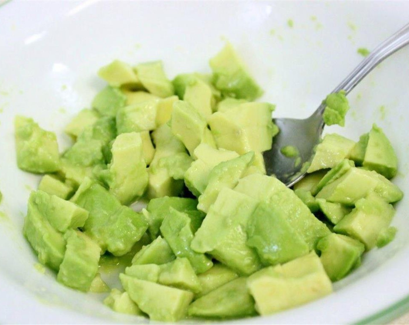 step 5 Add the juice from Lime (1/2) into the avocado, and stir gently to combine.