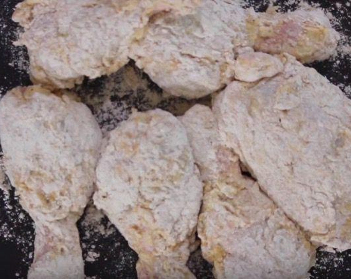 step 4 Thoroughly coat the chicken in the flour and spice mixture.