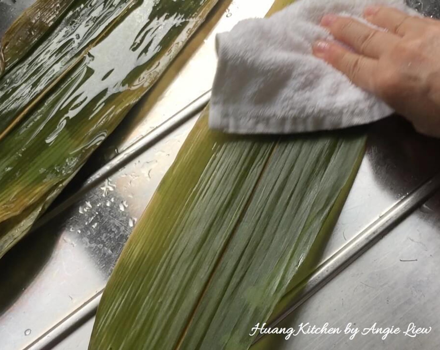 step 27 Remove the bamboo leaves from the wok to cool. Untie the bamboo leaves and use a clean cloth to wipe both sides of each bamboo leaf.
