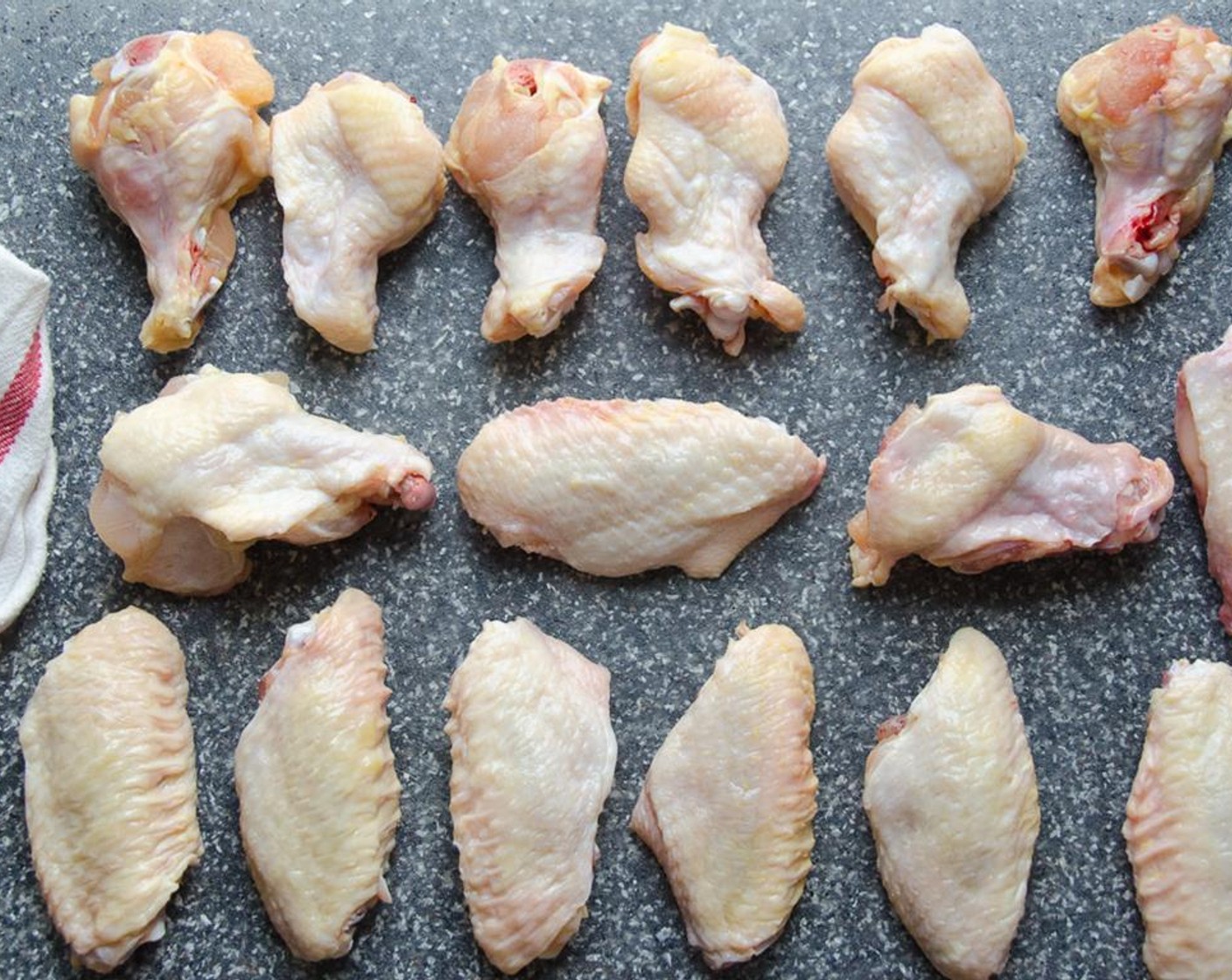 step 3 Cut the Chicken Wings (4 lb) into sections: drums, flats and tips. Use a sharp chef's knife to cut between the joints of the drums and flats, and flats and tips. Save tips for making stock.