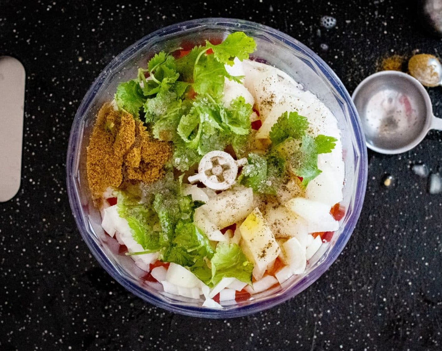 step 1 Place the Tomatoes (2), Red Onion (1), Fresh Cilantro (2/3 cup), Garlic (1 clove), 2 Tbsp of Lime (1), Salt (1/2 tsp), Ground Black Pepper (1/4 tsp), Ground Cumin (1/4 tsp), Chili Powder (1/4 tsp), and Extra-Virgin Olive Oil (1 Tbsp) in a food processor and blitz for 10-30 seconds until blended into fine pieces (Don’t blend for too long, you still want small pieces, not a paste)