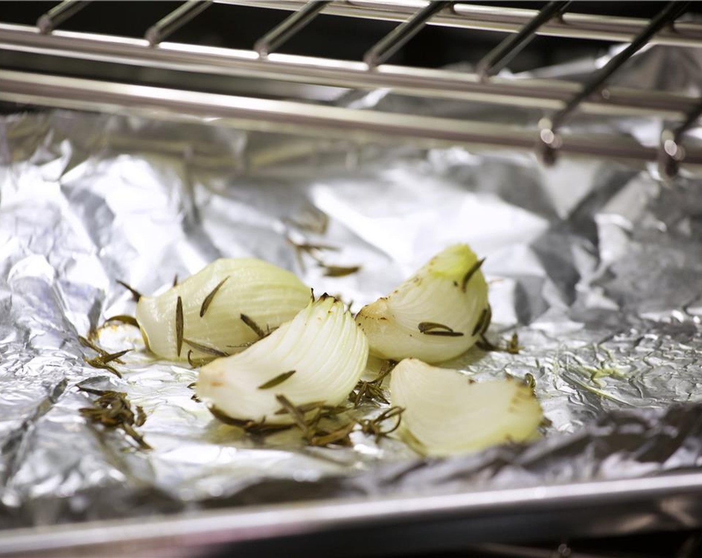 step 4 Add the onion and rosemary mixture evenly onto a sheet pan lined with foil and roast for 15 minutes until golden brown and translucent. Remove from oven and keep warm.