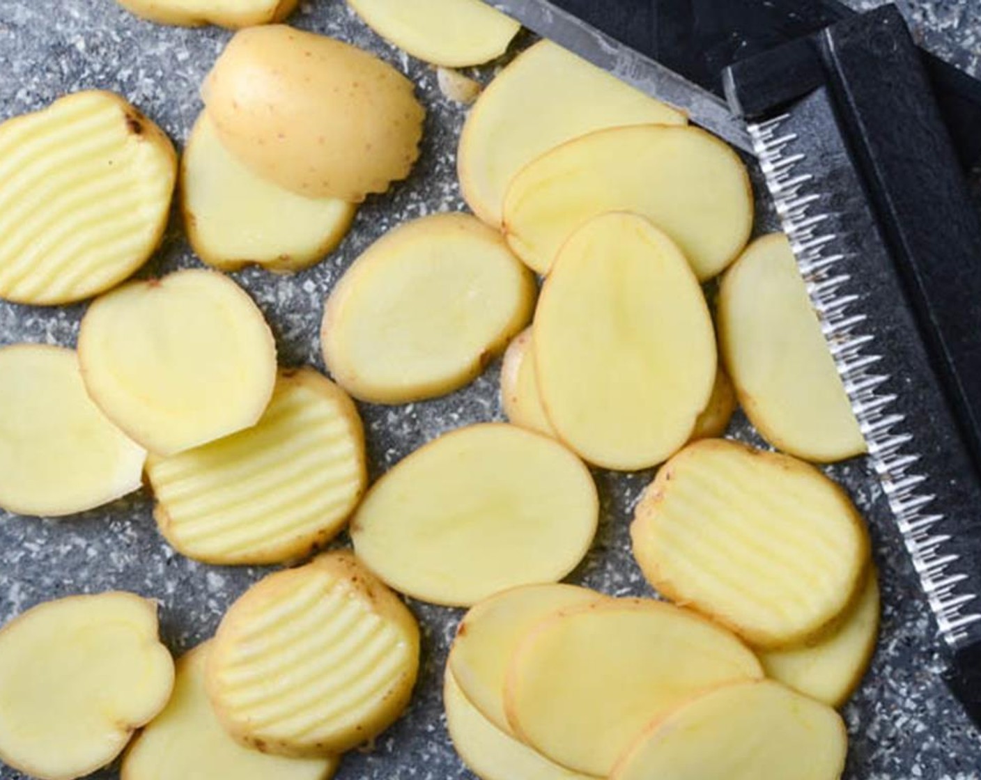 step 2 Using a sharp knife or mandoline, slice the Baby Dutch Potatoes (6) into 1/4-inch slices.