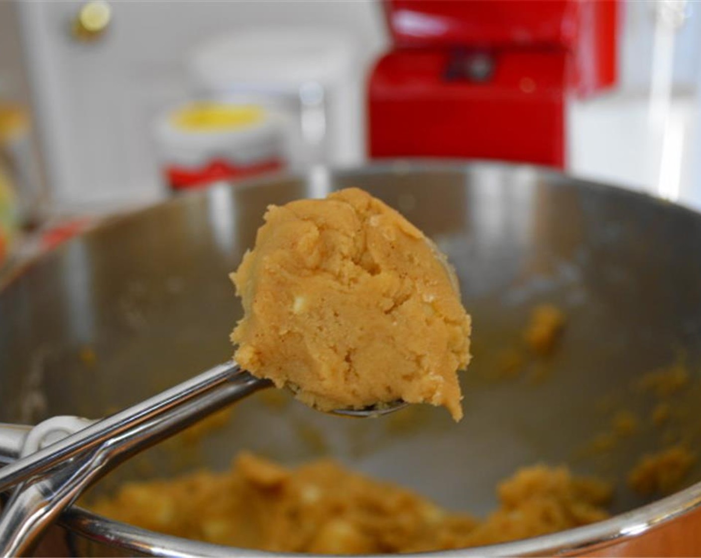 step 6 Use a cookie scoop to scoop up uniform balls of dough and roll them in your clean hands to smooth them out. Coat them all in cinnamon sugar mixture before laying them out on the lined cookie sheet.