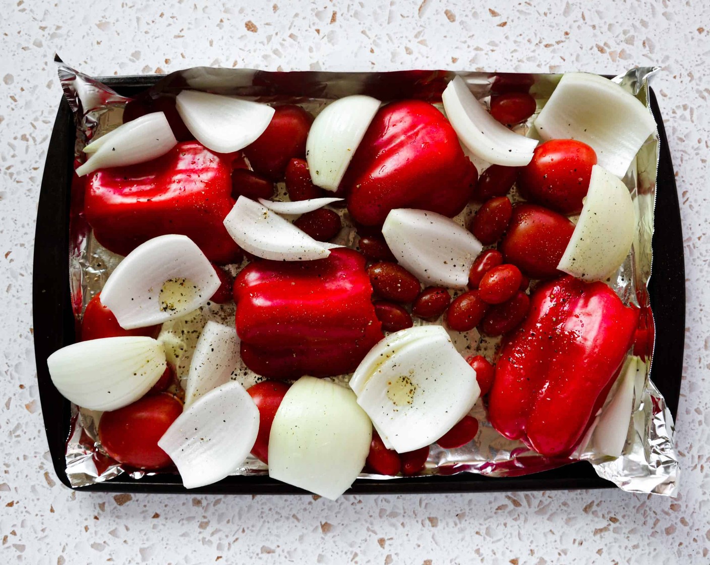 step 2 Place the Red Bell Peppers (2), Roma Tomatoes (3), Cherry Tomato (1 cup), and Yellow Onion (1) on aluminum foil on a 9×13-inch baking sheet. Toss with Avocado Oil (as needed) and lightly season with Salt (to taste) and Ground Black Pepper (to taste).