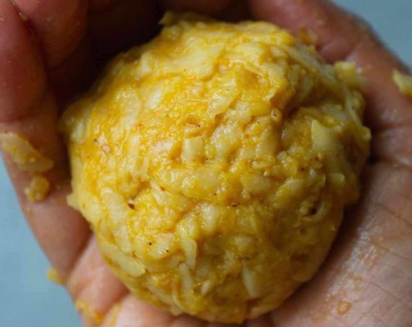 step 7 Heat about 1/4 inch of oil in a skillet to 325 degrees F (162 degrees C). Take a lemon-sized amount of the potato mixture and roll it into a ball.