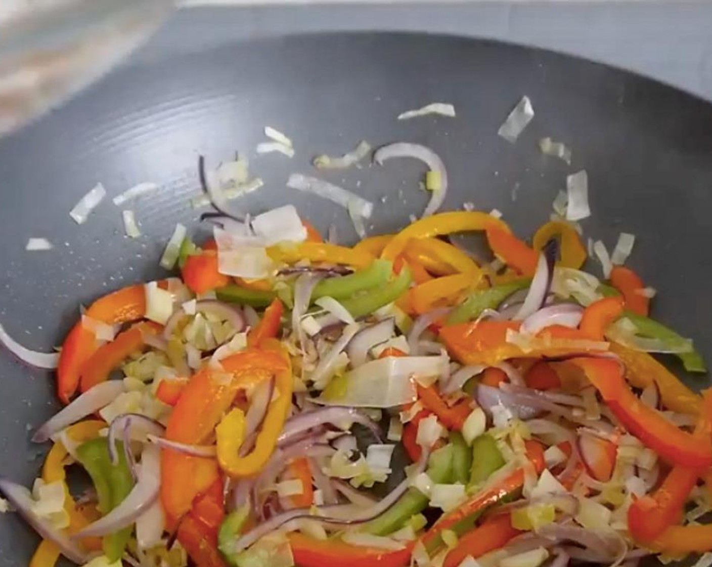 step 1 In a pan add some Vegetable Oil (as needed) and stir fry the Onion (1), Green Bell Pepper (1/4), Red Chili Pepper (1/4), Orange Bell Pepper (1/4), Garlic (2 cloves) and Leek (1/2). Leave to cook for about 10 minutes or until the vegetables are halfway cooked but still have some crunch.