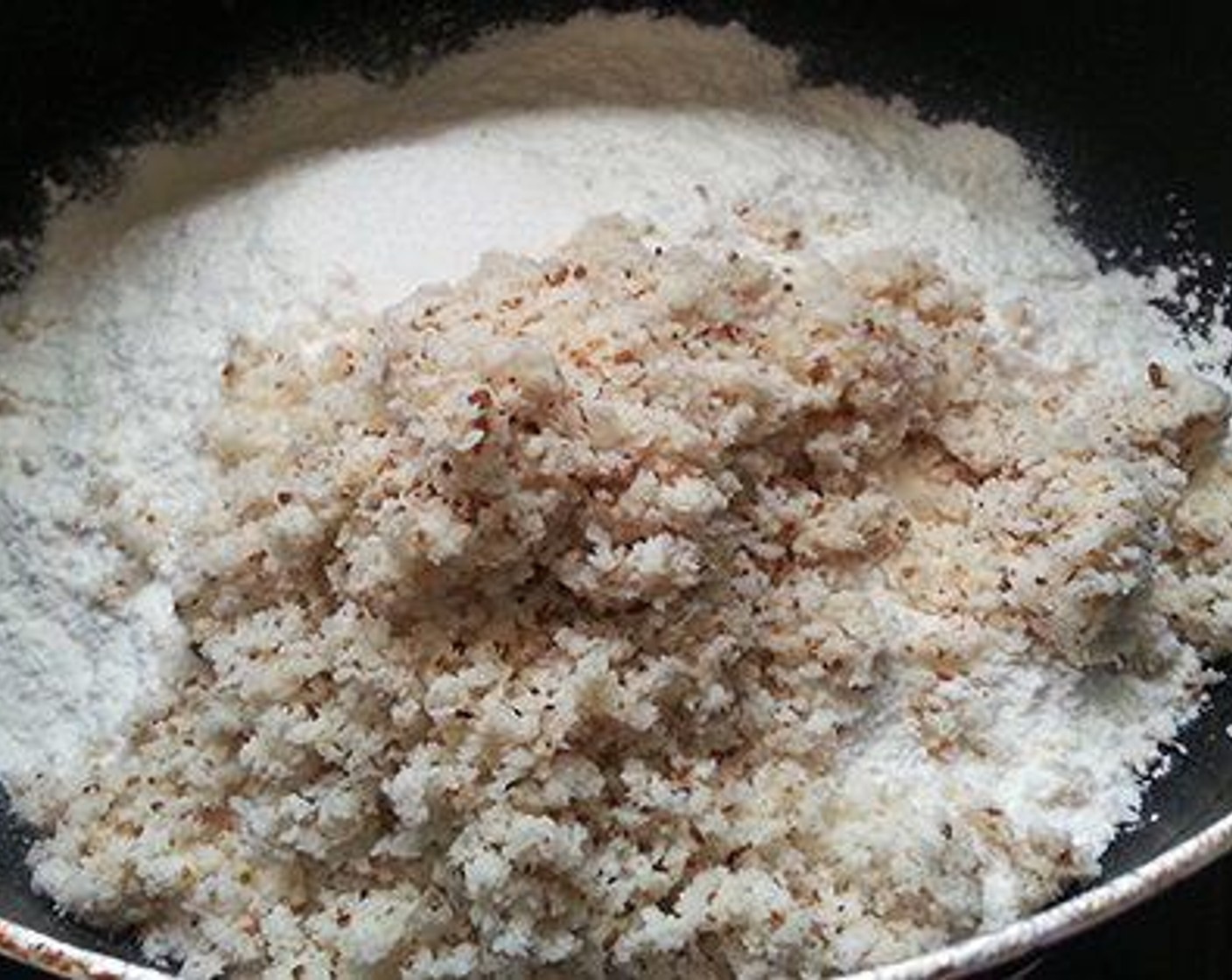 step 1 Pour Water (1 1/4 cups) to a pan and let it poil. Crush Coconut (1/2 cup) and Ground Cumin (1/2 tsp). Add the crushed coconut mix to the Rice Flour (1 cup) and combine. When the water boils add salt and Oil (1 Tbsp) and simmer the flame. Add the rice flour mix to the water and combine well.