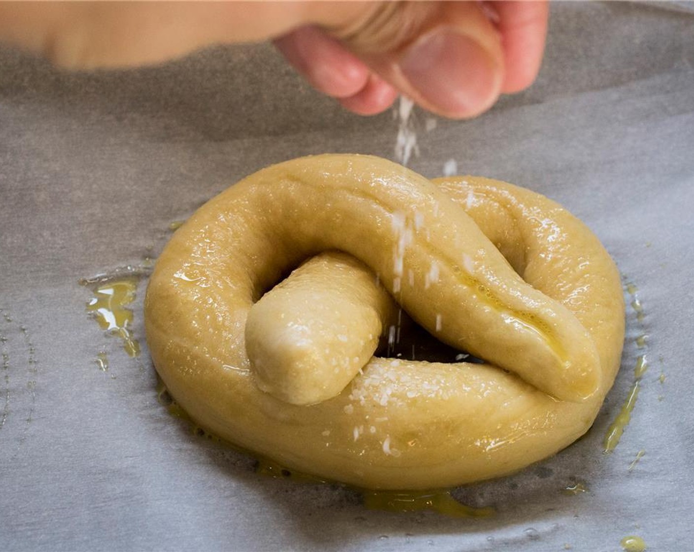 step 12 Beat Egg (1) yolk with 1 tablespoon of water. Brush each pretzel with the egg wash. Sprinkle with Sea Salt (to taste) just before transferring them to the oven. Place in the oven and bake for 15 to 18 minutes.