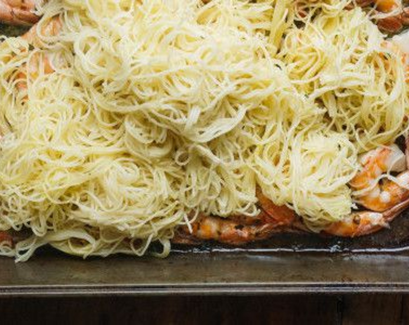 step 8 Bring a large pot of salted water to a boil. Cook the Angel Hair Pasta (8 oz) according to package directions. Drain and add directly to the roasted shrimp. Toss to coat in butter sauce.