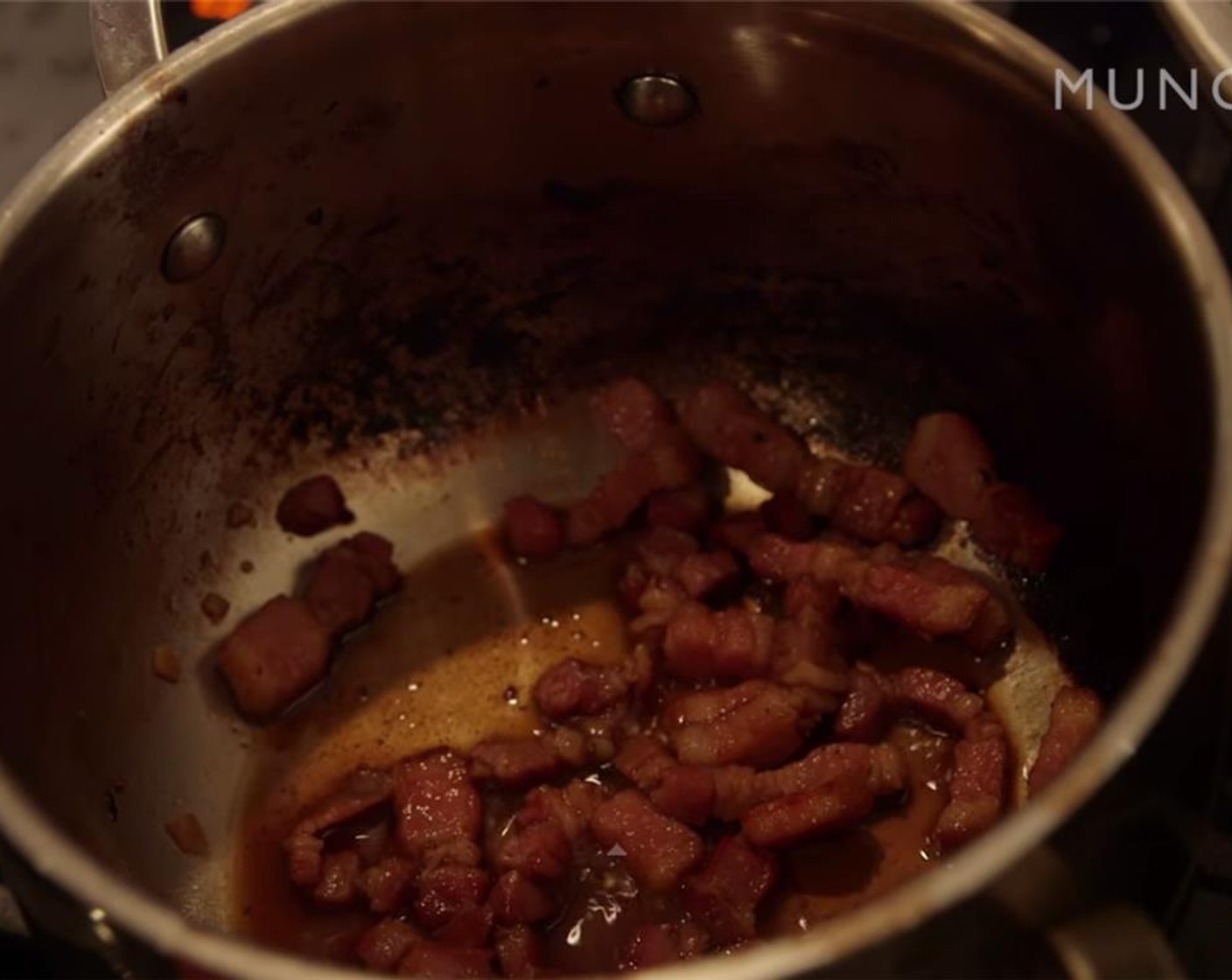 step 6 In a separate pan, render lardons over medium heat until crispy. Add Brown Sugar (2 pinches) to the pan and mix to incorporate, stirring constantly. It will caramelize, so make sure that it doesn't burn. Now, if you want to add Courvoisier (to taste) be extremely careful: take the pan off the heat, add a dash of booze, and light a match. Add back to low heat and allow alcohol to burn off.