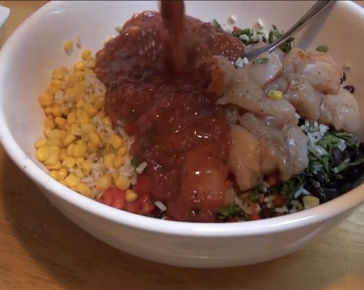 step 6 In a large bowl, add the cooked Brown Rice (2 1/2 Tbsp). Mix in Frozen Corn Kernels (3/4 cup), bell pepper, Canned Black Beans (1/2 cup), cilantro, chicken cubes, and Salsa (1 cup).