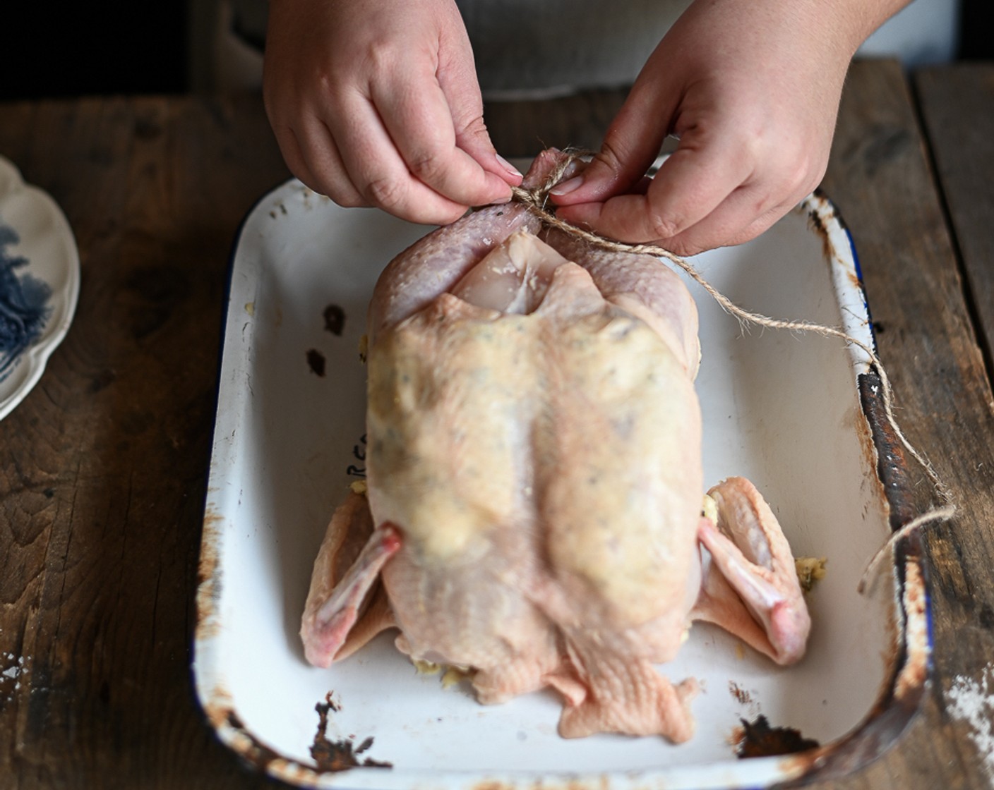 step 5 Stuff the cavity of the chicken with a halved lemon and extra rosemary sprigs. Use kitchen twine to securely truss up the legs of the chicken.