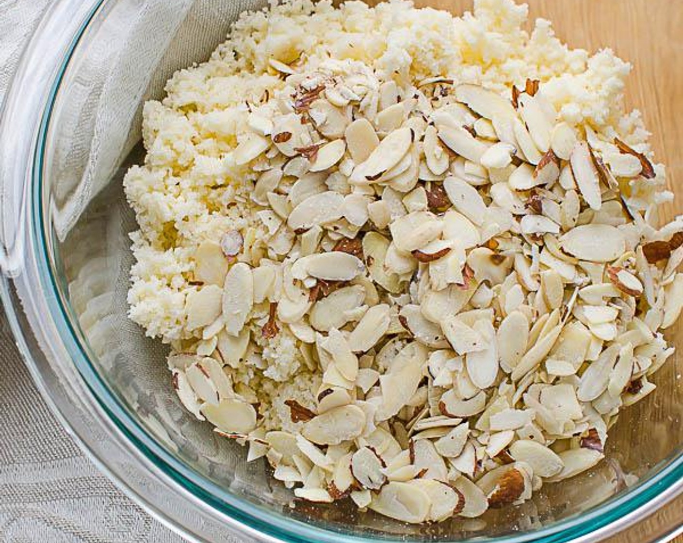 step 5 Transfer the streusel to a small bowl and add the Sliced Almonds (1/2 cup). Toss with your fingers to combine.