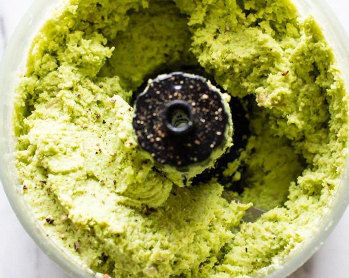 step 2 Combine your edamame, Sunflower Seeds (1/4 cup), and Garlic (1 clove) in a food processor. Blend then add Olive Oil (3 Tbsp), juice from Lemon (1), Sea Salt (to taste), and Ground Black Pepper (to taste). Blend again until thick pesto is formed.