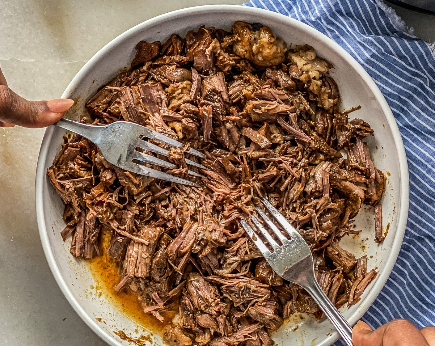 step 5 After the steam has been released, remove meat and shred with two forks. Optional: Boil the leftover broth until it has reduced to 1-2 cups, about 30 minutes. Use it as a sauce to serve with your tacos.