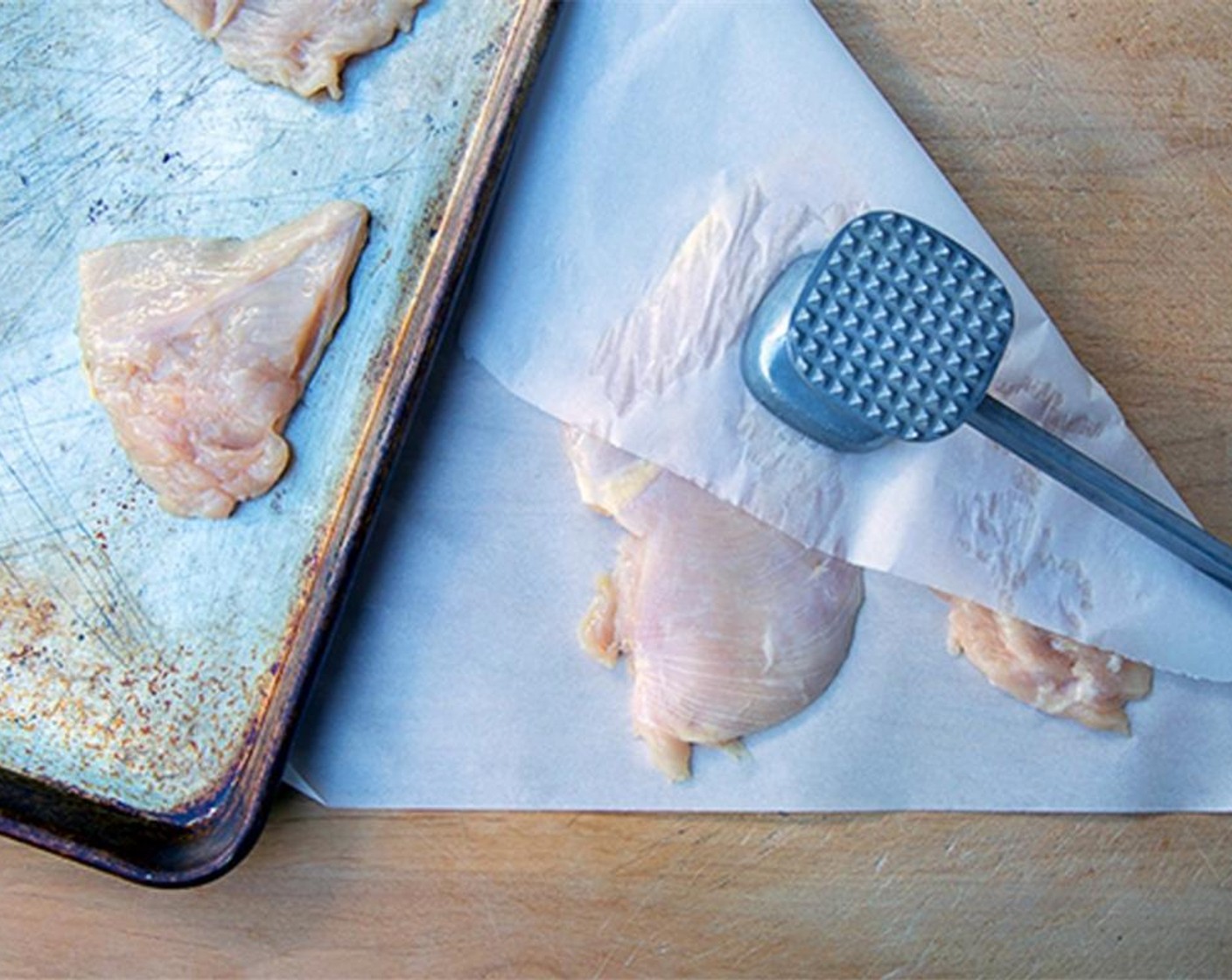 step 2 Pound the chicken to an even thickness and place in a shallow baking pan.