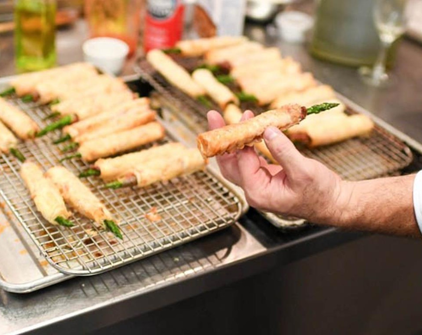 step 6 Place a ham-wrapped asparagus spear on the phyllo with the tip sticking out over the phyllo and begin to roll it up, brushing a little butter on the phyllo sticks as you roll. Brush with a little more butter and dust it lightly with more parmesan.