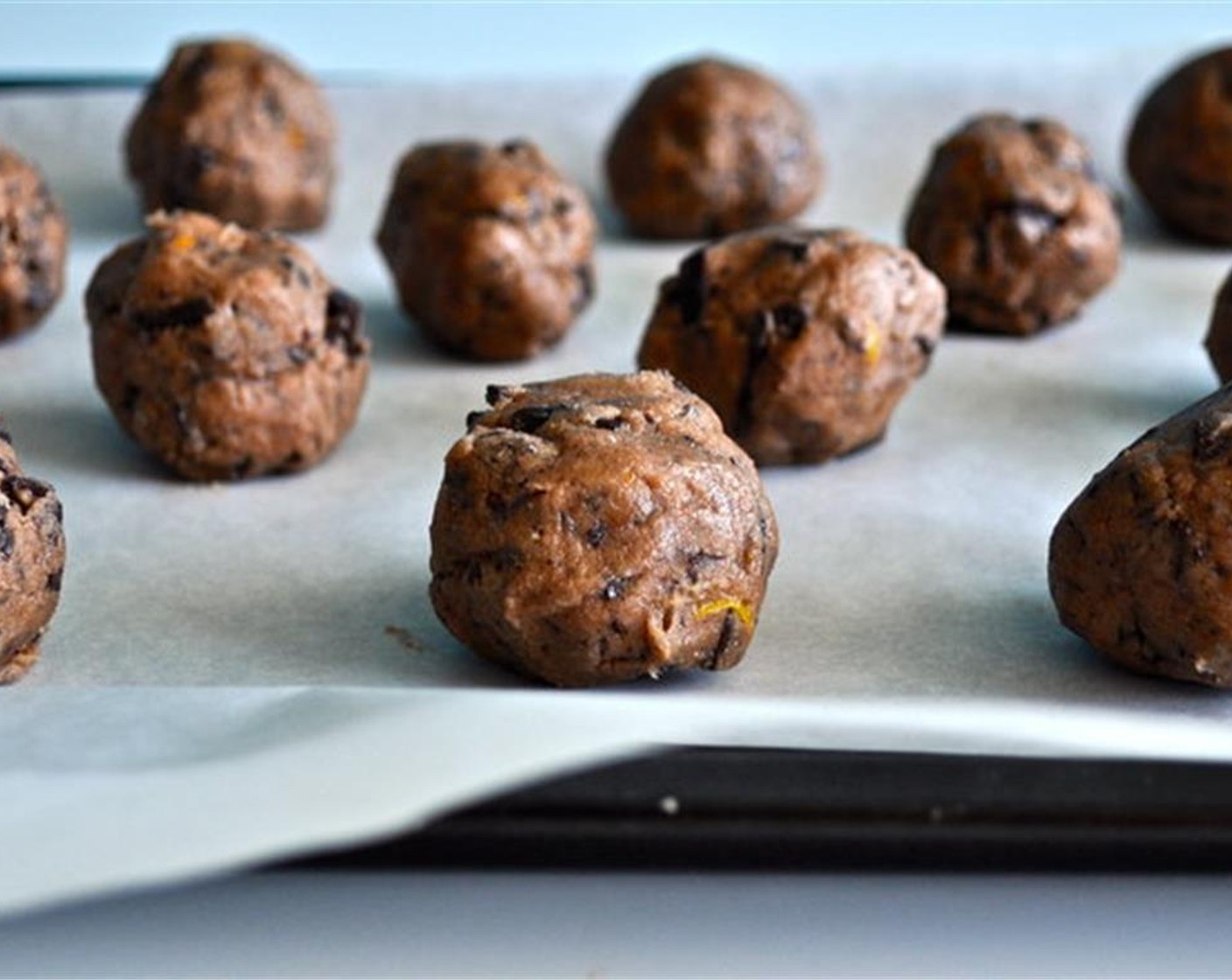 step 6 Divide dough into 2 1/2 tablespoon (about 50g) pieces. Roll each piece into a ball. You will have about 15 balls. Place on parchment lined baking sheet, about 2 centimetres apart.