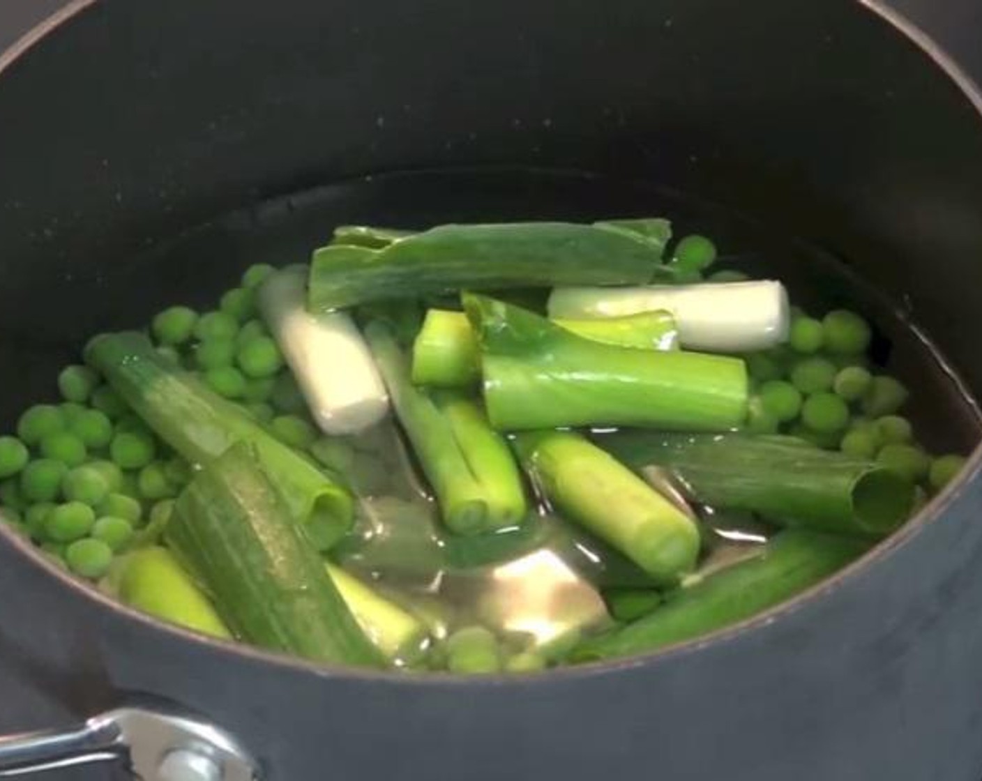 step 1 Into a pot over high heat, mix the Water (3 cups), Salt (1 tsp), juice from Lemon (1), Frozen Green Peas (2 cups), and Scallion (1 bunch).