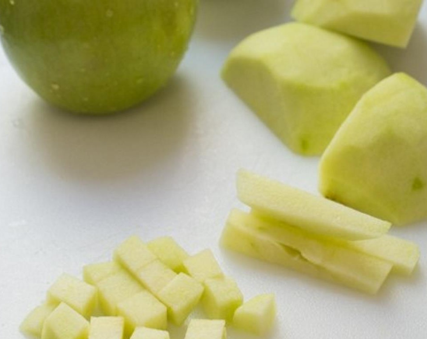 step 6 Peel the skin off the Green Apples (2) then cut them into small dices (discard the center core). Pour Simply Organic Cinnamon, Ground (1/4 tsp), Ground Nutmeg (1 pinch), and Granulated Sugar (1 teaspoon) over the diced green apple. Mix well.