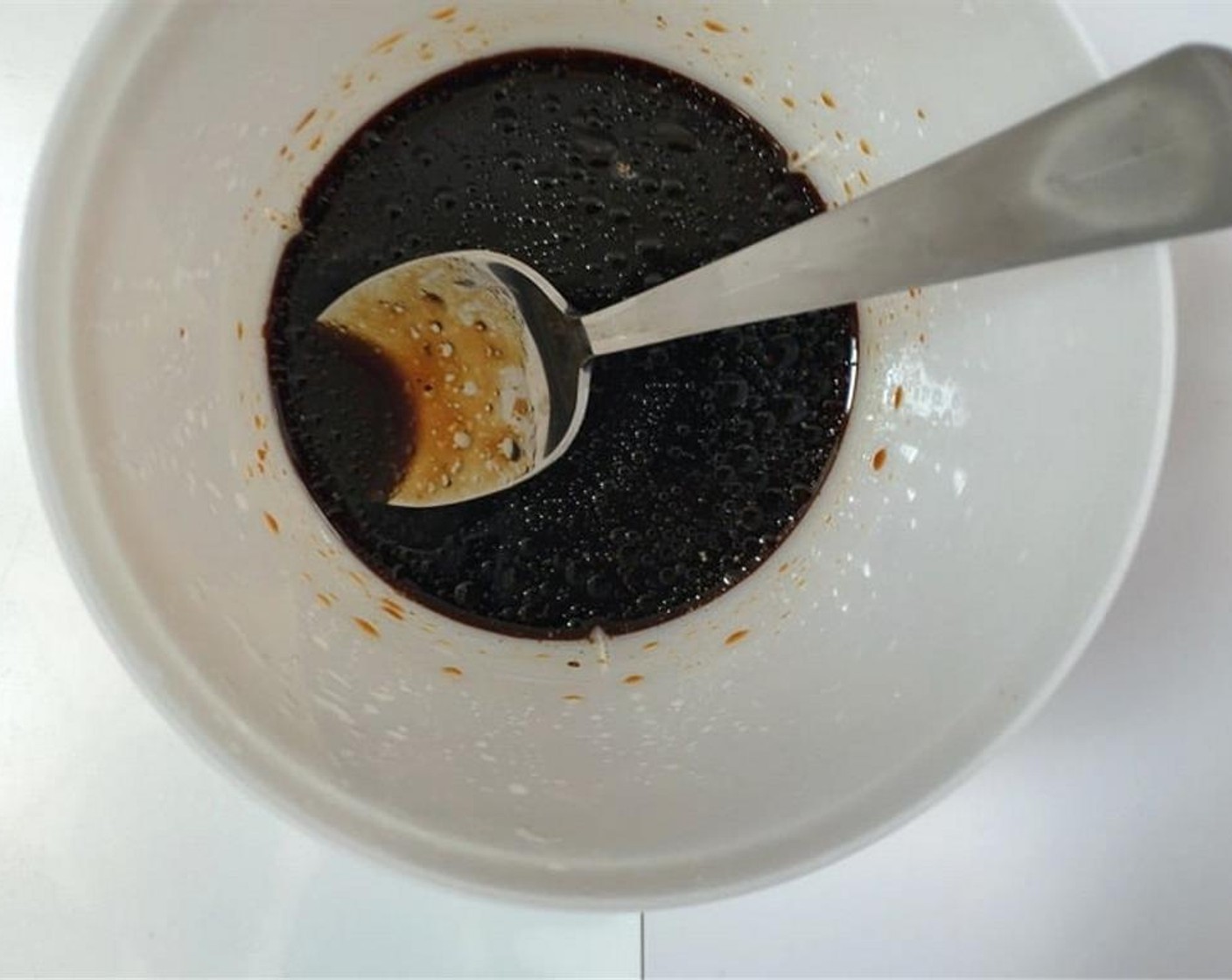 step 1 Pour the Sesame Oil (1 tsp), Dark Soy Sauce (1 Tbsp), Fish Sauce (1 tsp), Oyster Sauce (1 tsp), and Shaoxing Cooking Wine (1 Tbsp) in a small cup. Season with Salt (1 pinch), Ground Black Pepper (1 pinch), and Granulated Sugar (1 pinch). Stir well and set aside.