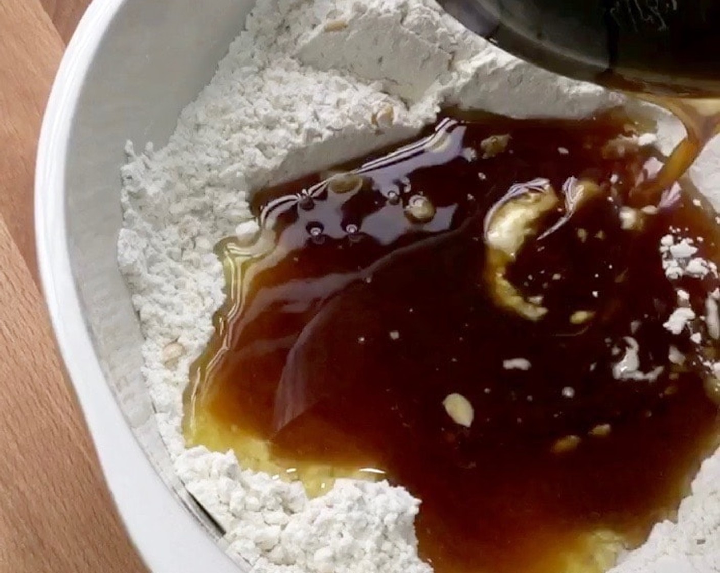 step 8 Make a well in the centre and slowly add in the golden syrup mixture.