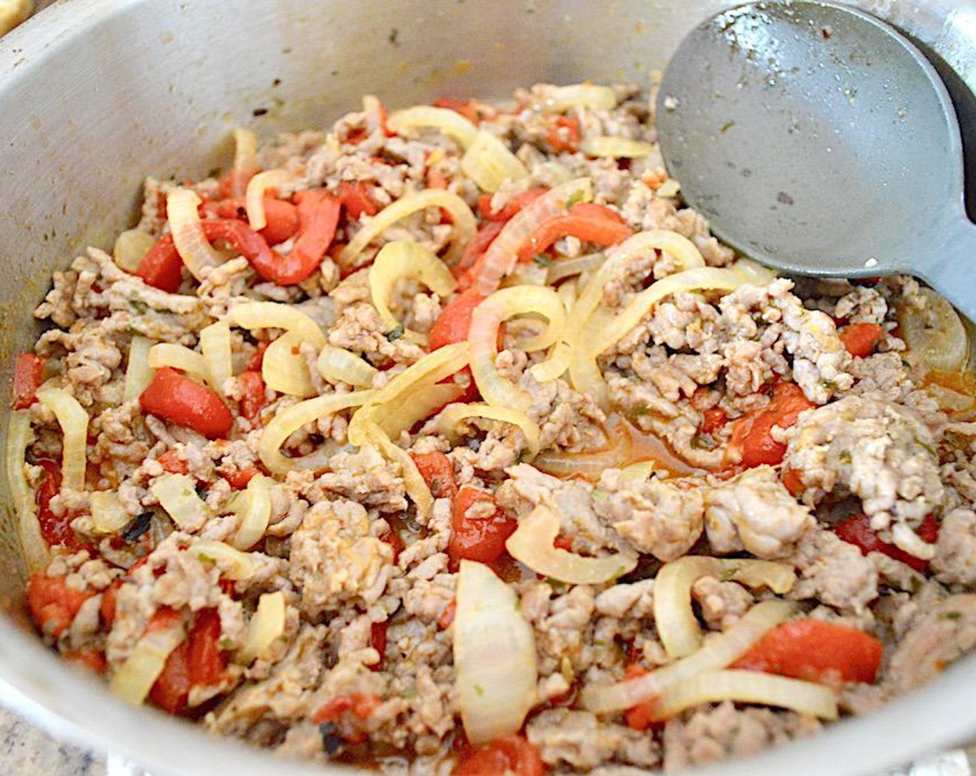 step 3 Add in the Onion (1) and Roasted Red Peppers (1 jar) when the sausage is almost done and let them soften for a couple of minutes. While that all cooks, season the mixture with the McCormick® Garlic Powder (1 tsp) ,  Dried Parsley (1 tsp), Salt (1 pinch) and Crushed Red Pepper Flakes (1 pinch).