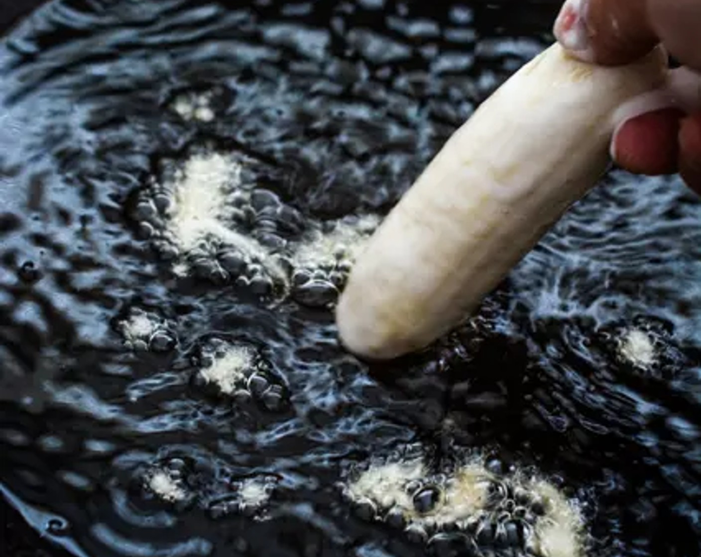 step 4 Coat the Bananas (6) in the batter. When the oil is ready, carefully place the bananas in the oil and fry them in small batches till golden brown.