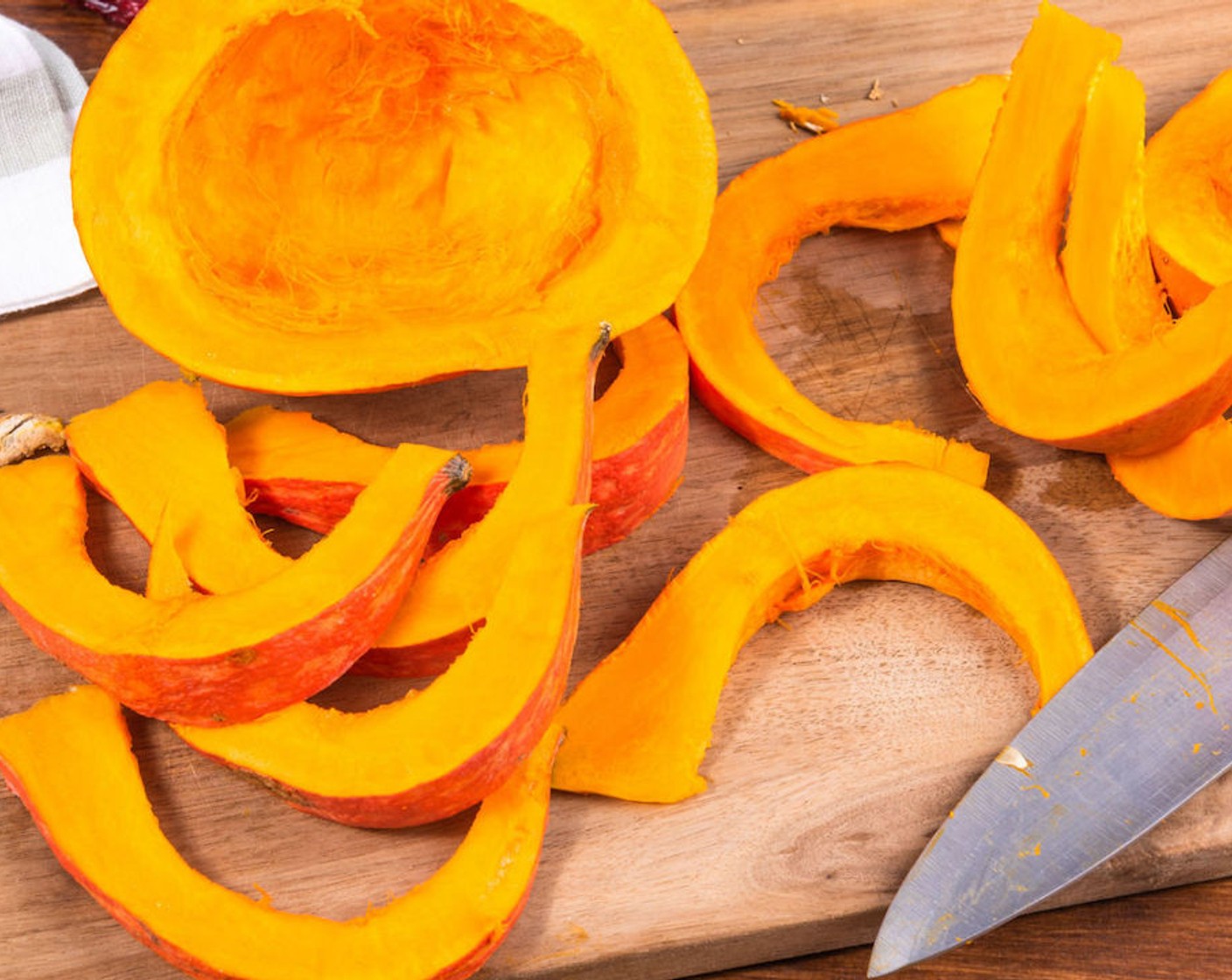 step 2 Cut the Sugar Pumpkin (1) in half and scrape out the seeds using a spoon. Cut the pumpkin into slices about 1-inch thick using a sharp knife.