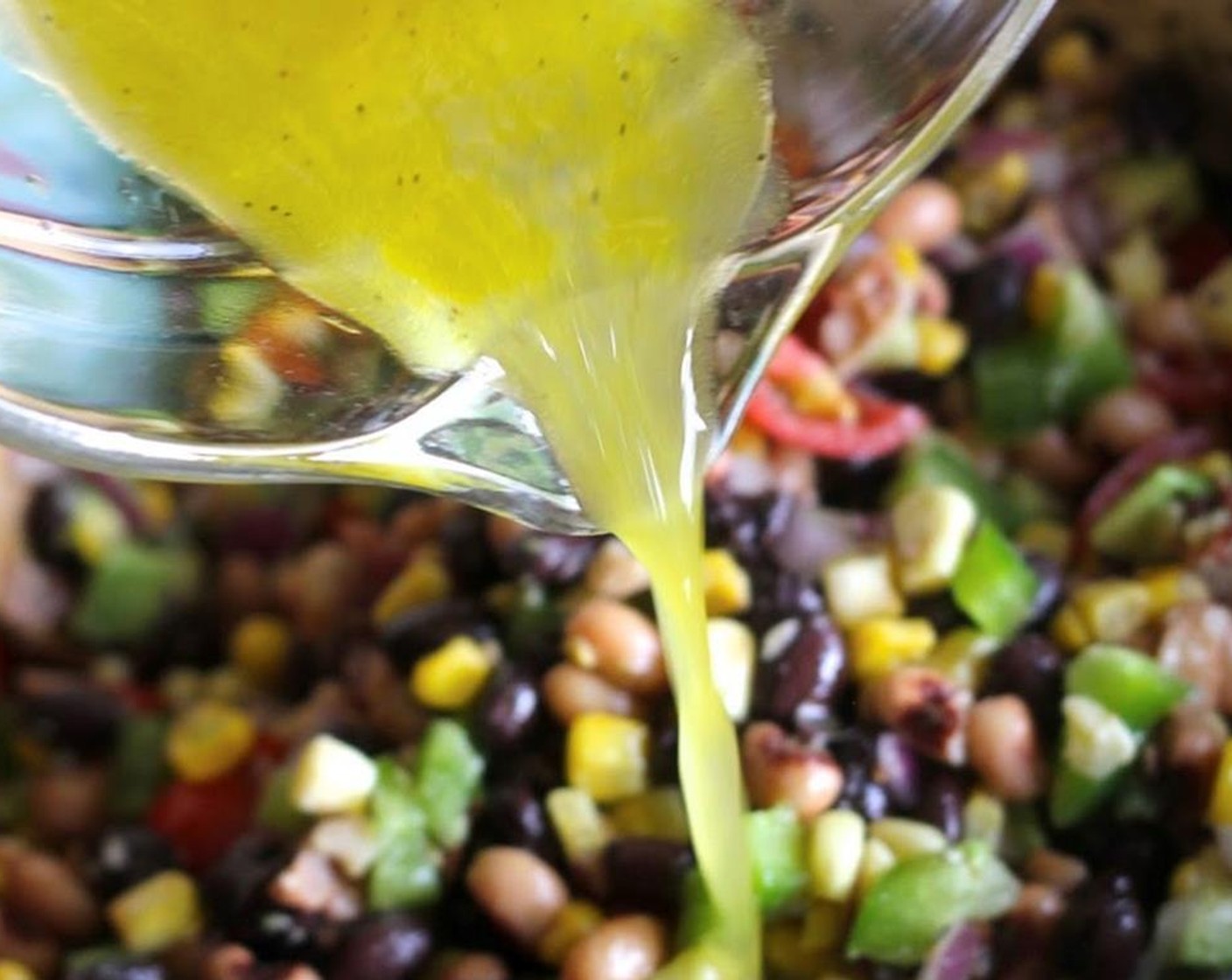 step 6 Drizzle the dressing over the bean and vegetable mixture, then stir gently.