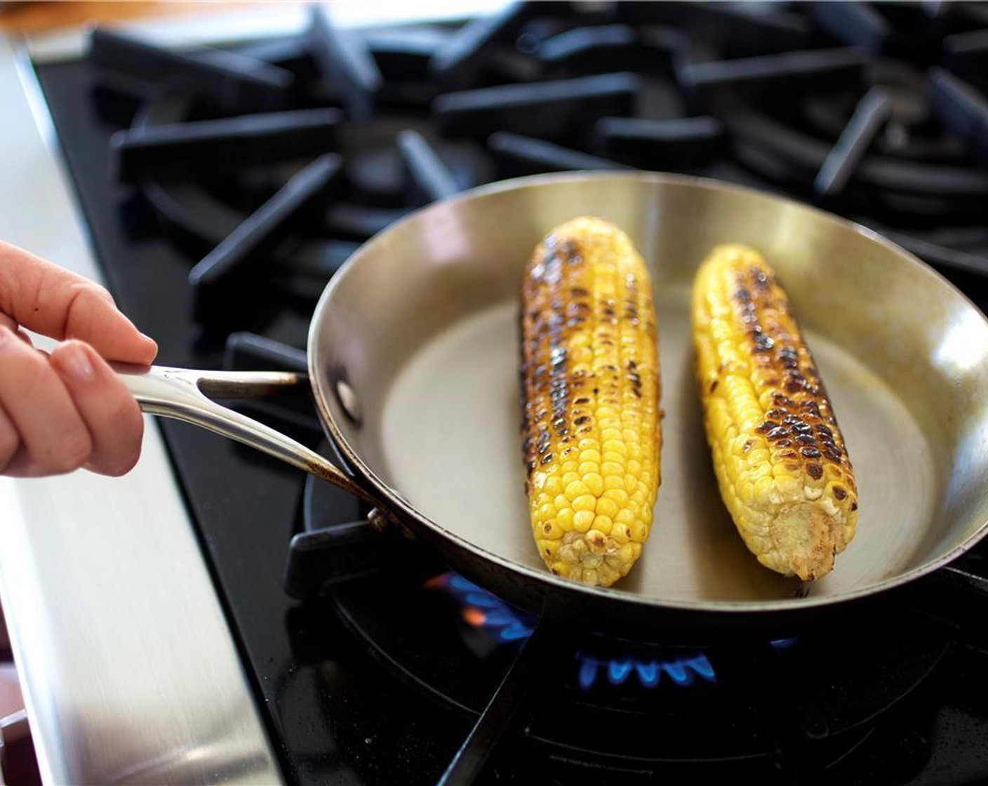 step 9 Wipe out the pan and paper towels and then heat over medium high heat. When the pan is hot, add the corn and sear, rotating the cobs so that each side gets a bit charred, about ten minutes.