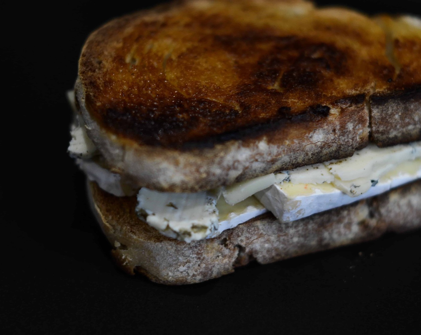 step 7 Oozy Gorgonzola Toastie: Butter (to taste) one side of each Ciabatta Bread (4 slices). Facing the buttered side out, layer the Gorgonzola Cheese (to taste) and Ripe Camembert (to taste) on top of one another – be generous to the point of greed.