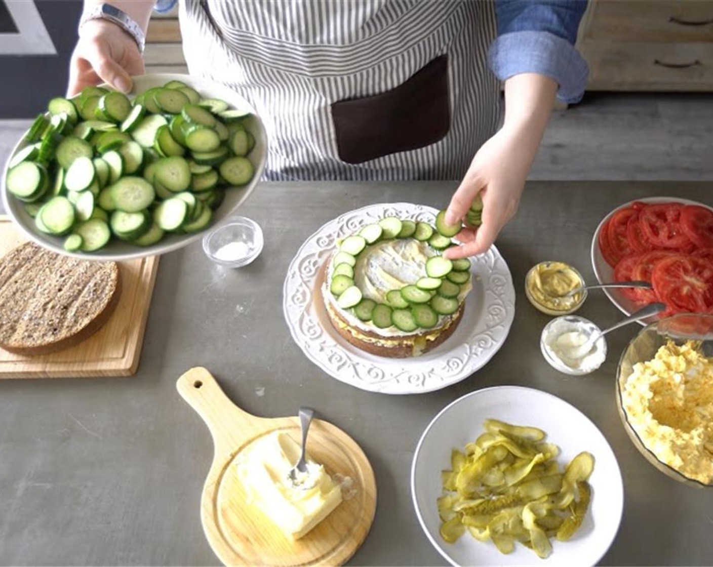 step 9 Layer Cucumber (1/2 cup) on to the cream cheese and mustard mixture. Start from the outer border of the bread and work your way into the center of the bread.