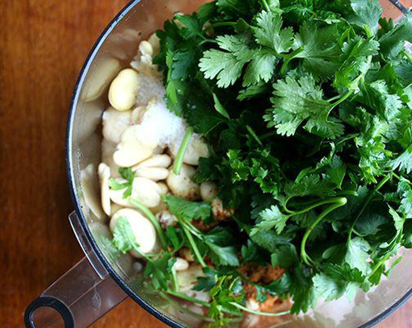 step 3 Add Garlic (2 cloves), Onion (1), Ground Coriander (1 tsp), Ground Cumin (1 Tbsp), Cayenne Pepper (1 tsp), Fresh Parsley (1 cup), Kosher Salt (1 tsp), Ground Black Pepper (1/2 tsp), Baking Soda (1/2 tsp), and the juice from Lemon (1) to the food processor.