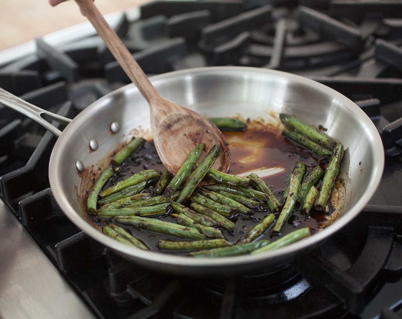 step 12 Add the sauce and cook for 3 minutes, until the sauce coats the green beans.