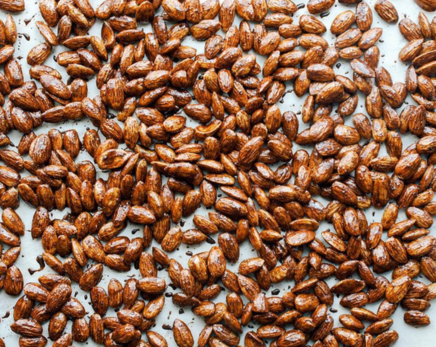 step 3 On a large baking sheet lined with parchment paper or lightly oiled, spread almonds in a single layer. It’s ok if they’re touching each other.