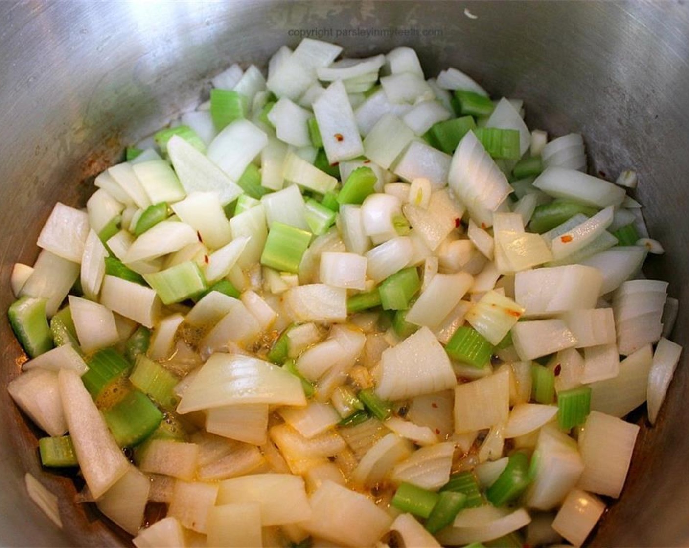 step 2 In a large soup pot, pour Vegetable Broth (1/2 cup) to cover the bottom of the pot. Add Crushed Red Pepper Flakes (1/2 tsp), White Onion (1), Celery (3 stalks), and Garlic (3 cloves). Cook over medium heat for 2 minutes, stirring frequently.