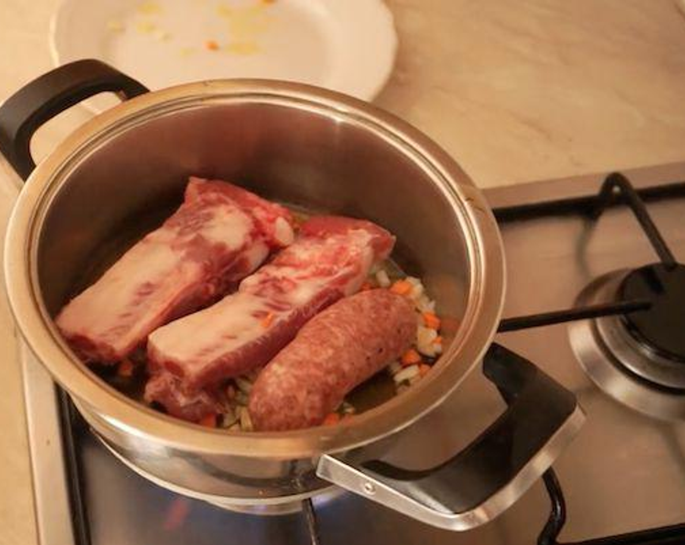 step 2 Leave it to fry for a minute or so before you add a Italian Pork Sausages with Fennel (1) and Pork Ribs (2) to the pot, along with Pork (1 lb). Add the minced pork a little bit at a time so it can brown.