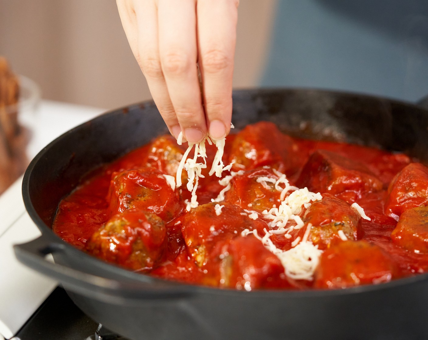 step 9 Turn off the heat, and arrange all the meatballs in the skillet if you cook in batches. Then pour in Marinara Sauce (1 jar). Sprinkle it with Mozzarella Cheese (4 Tbsp). Bake in the oven for about 5 more minutes or until the cheese is melted.