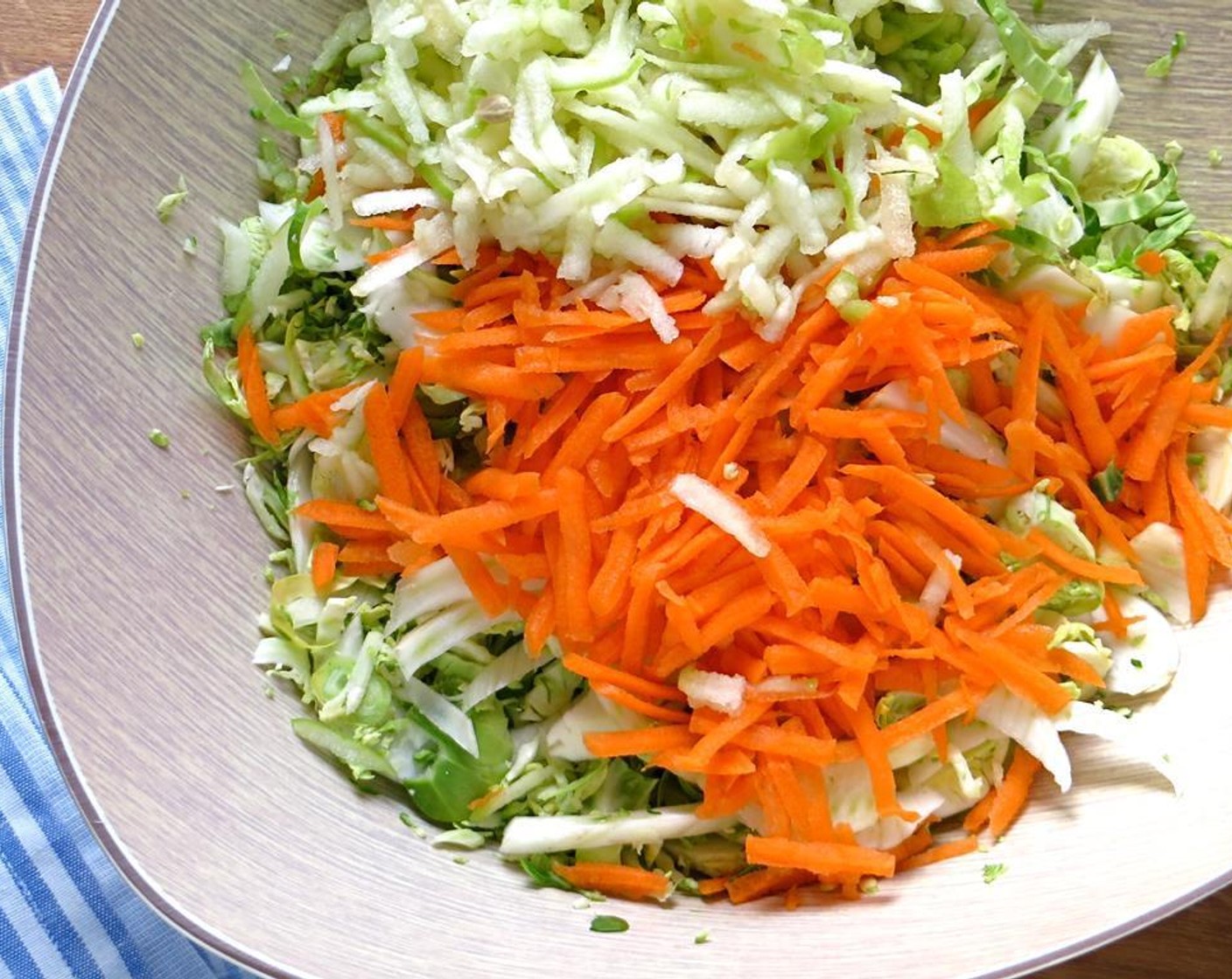 step 6 Combine the shredded Brussels sprouts, Granny Smith Apple (1), Carrot (1) and fennel in a large bowl. Add a squeeze of Lemons (to taste) and toss to combine.