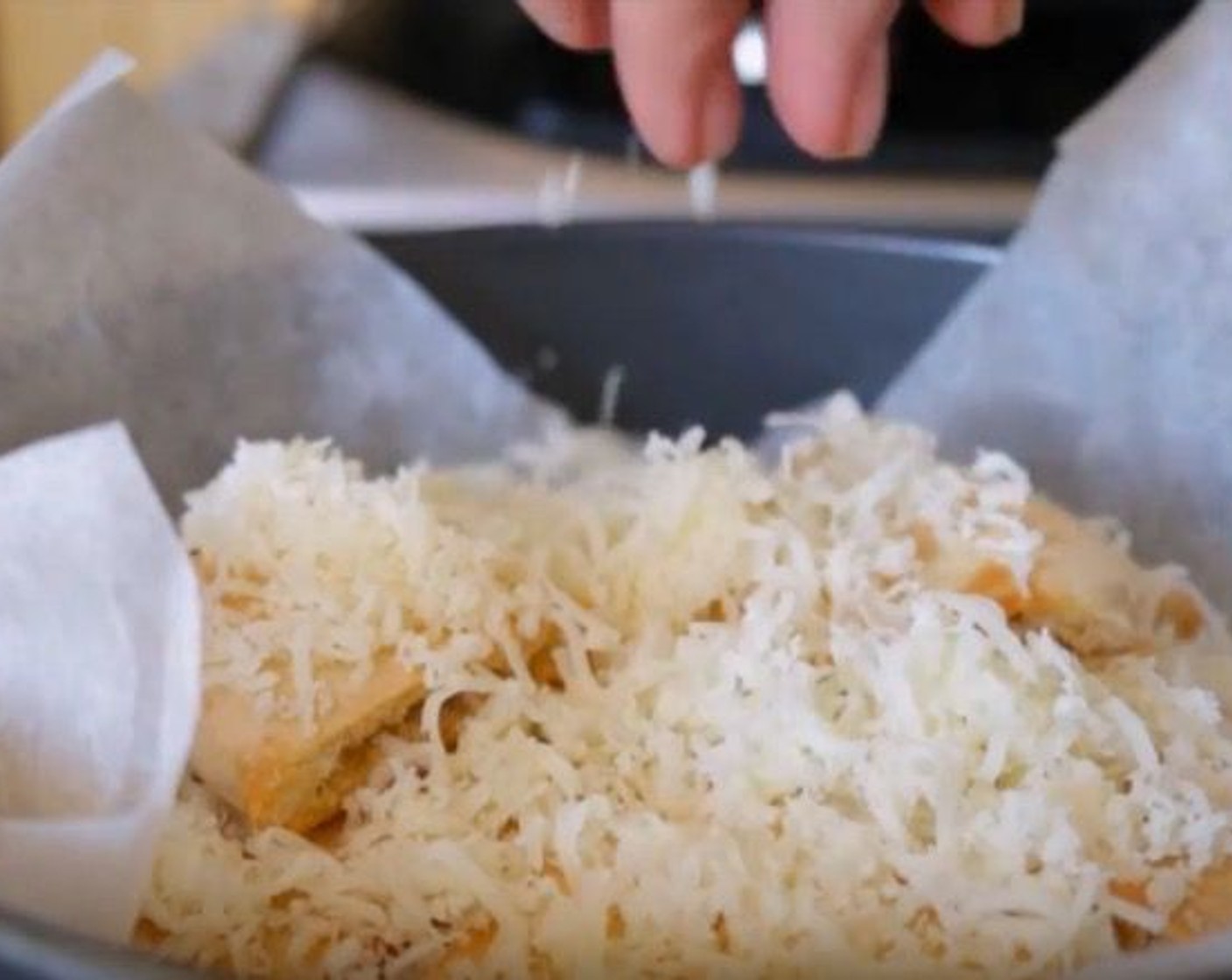 step 5 Add the pita chips to a round baking dish lined with parchment paper. Top them off with the Manchego Cheese (3/4 cup).