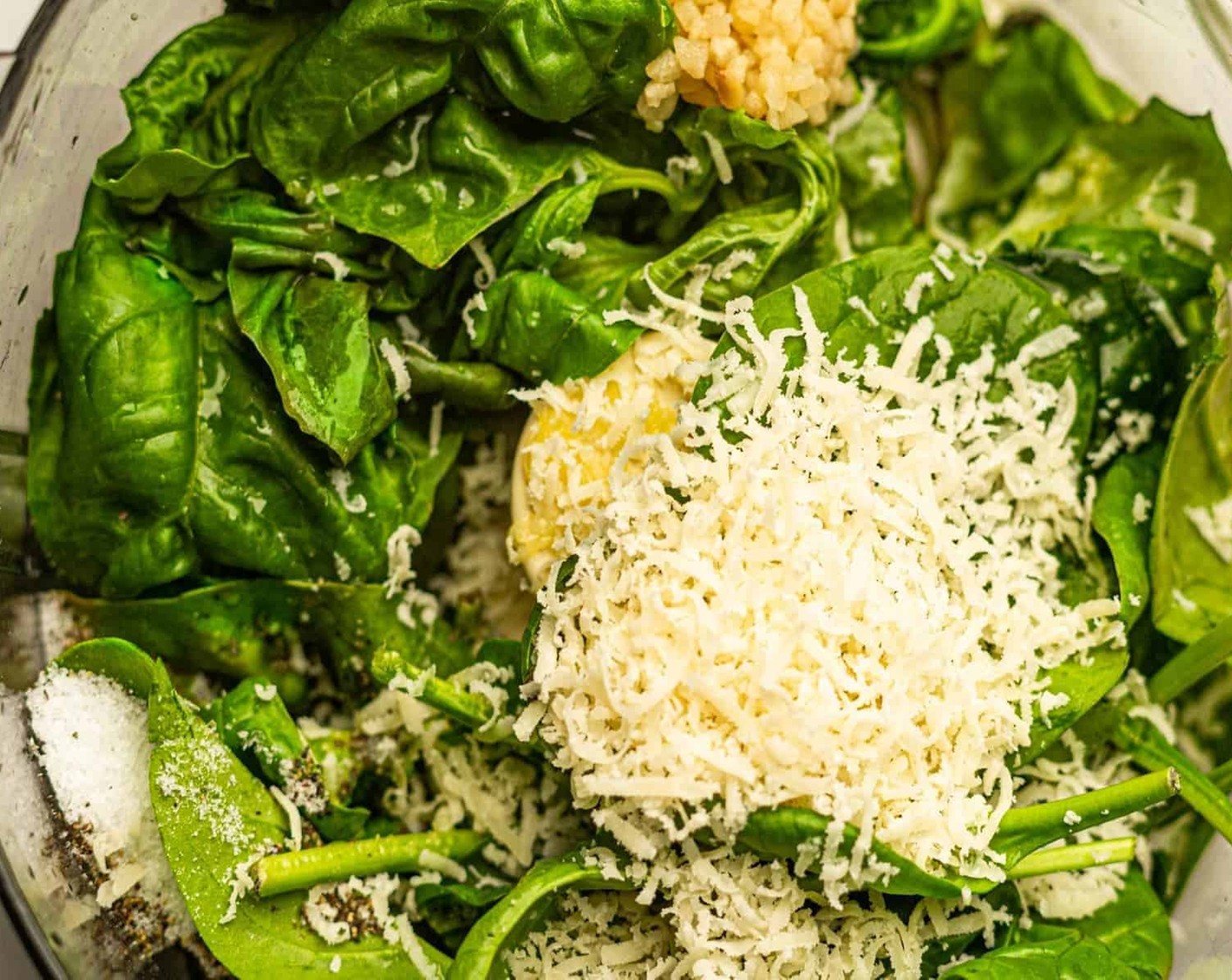 step 1 Add Fresh Basil (1 cup), Fresh Spinach (1 cup), Parmesan Cheese (4 Tbsp), Extra-Virgin Olive Oil (1/2 cup), Lemon Juice (1/2), Garlic (2 cloves), Salt (to taste), and Ground Black Pepper (to taste) to a high-powered blender or food processor and pulse until the mixture is smooth.