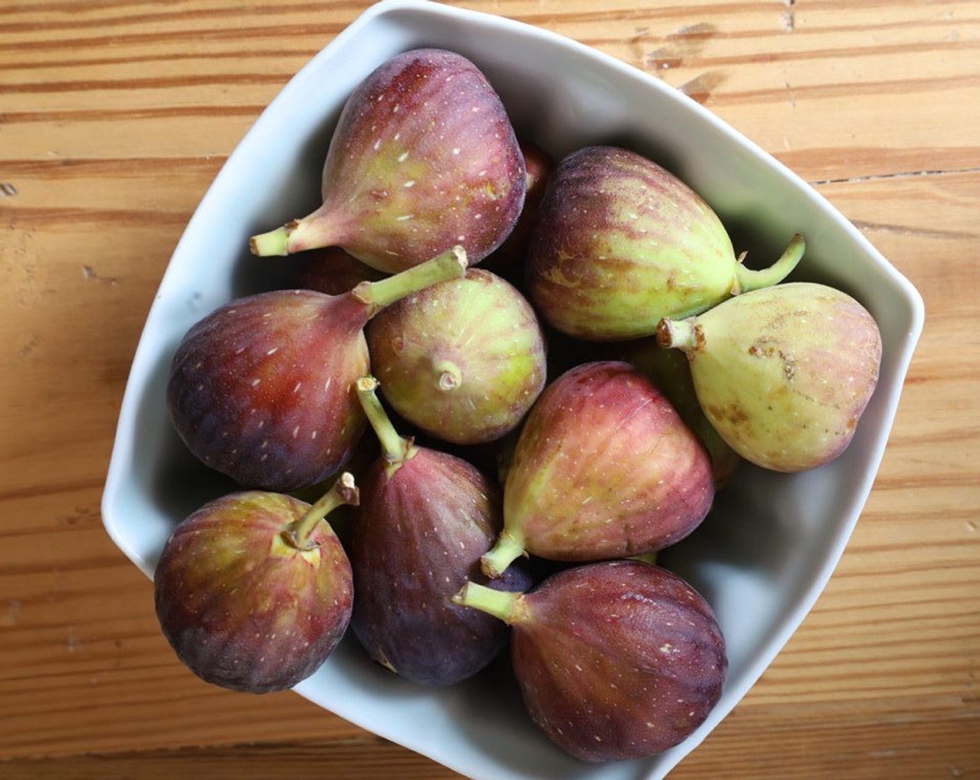 step 2 Cut the Figs (12) in half (or in quarters if large) through the stem. Place them in a small bowl, add 1 Tbsp of granulated sugar, and toss. Set aside.