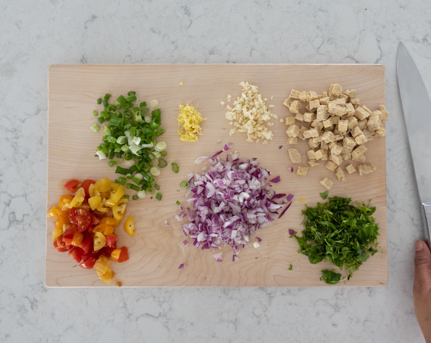 step 1 Prep all ingredients that need to be minced, chopped, or grated including Garlic (3 cloves), Red Onion (1/2), Tempeh (2 pckg), Fresh Ginger (1/2 Tbsp), Scallion (1 bunch) and Fresh Cilantro (1/2 cup).