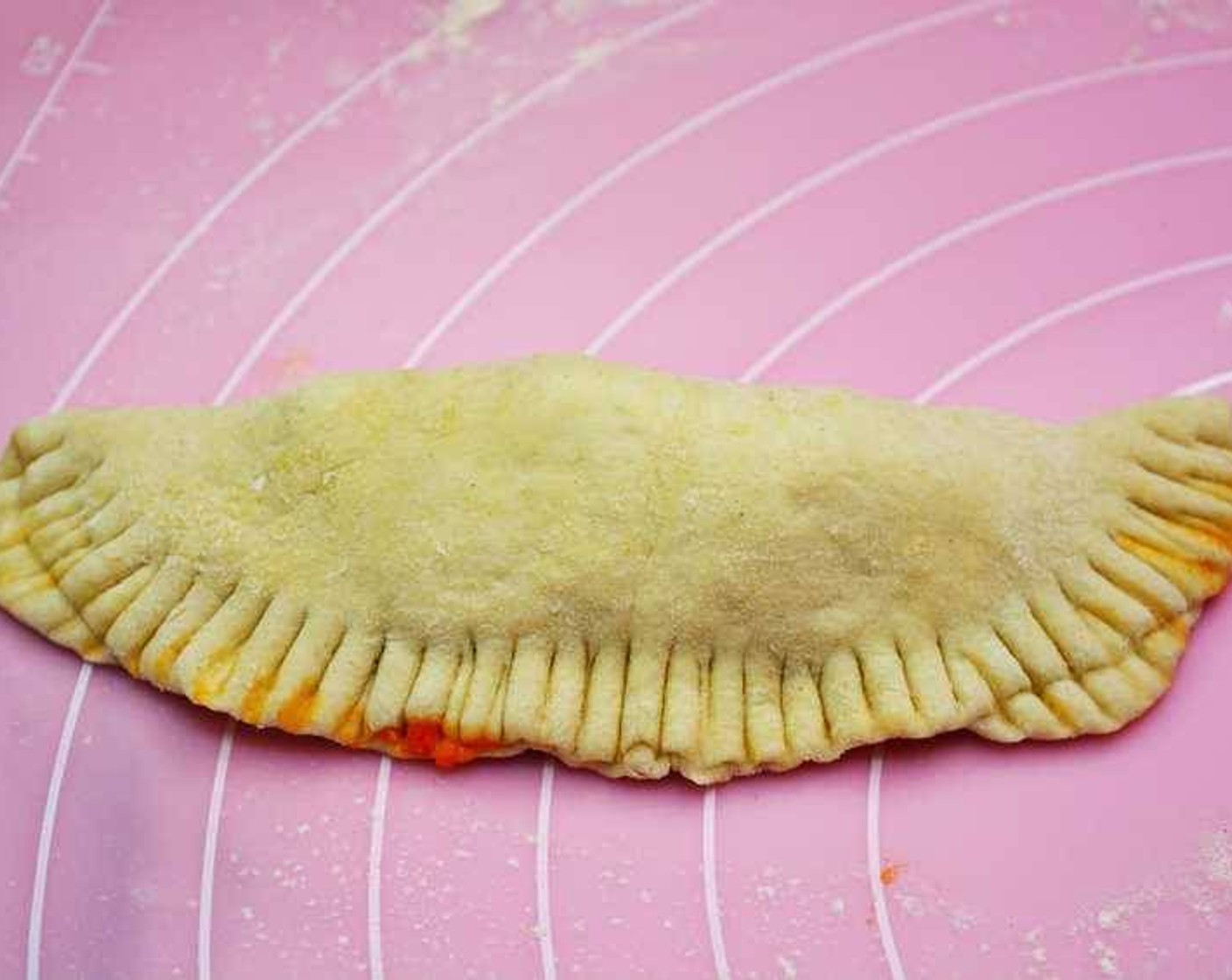 step 9 Brush the edges with water and seal the empanada. With a fork press along the edges to seal completely.